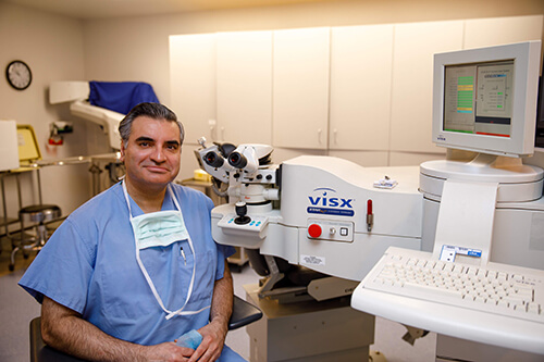 Dr. Husain Next to VISX Machine