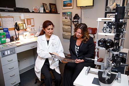 Doctor and Patient Reading Off a Chart Together