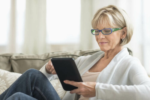 Woman looking at forms on tablet